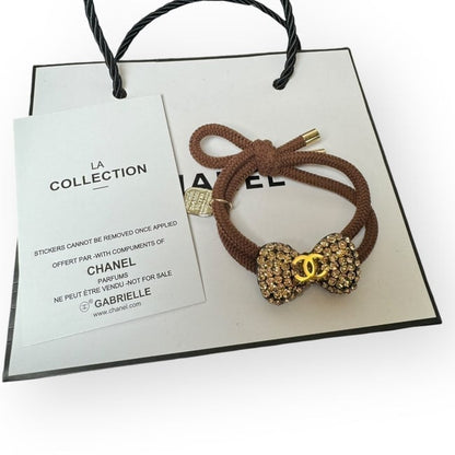 VIP/GWP Gold Rhinestone CC Bow Hair Tie